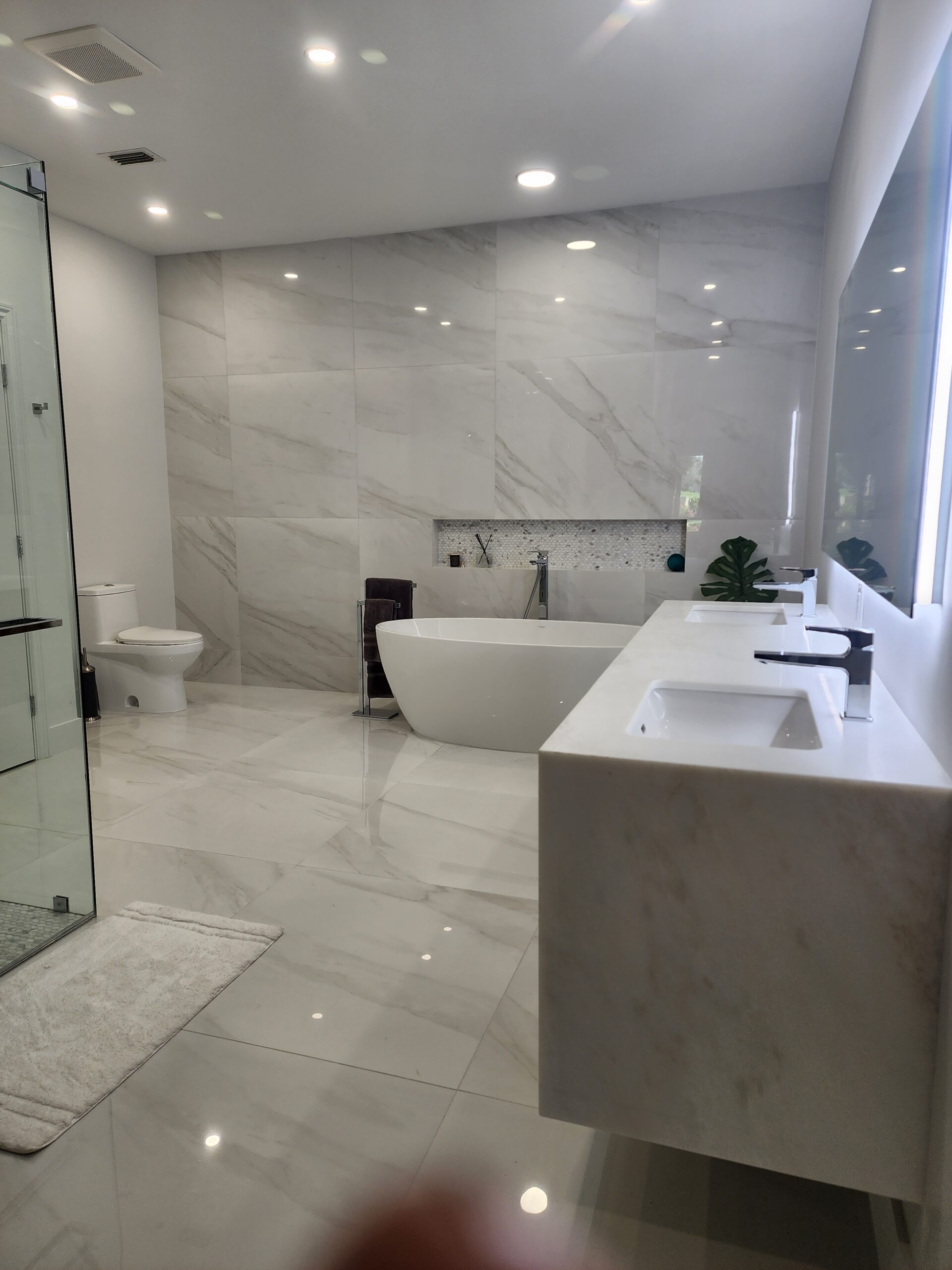 A spacious bathroom featuring a walk-in shower and a luxurious bathtub, designed for comfort and relaxation.