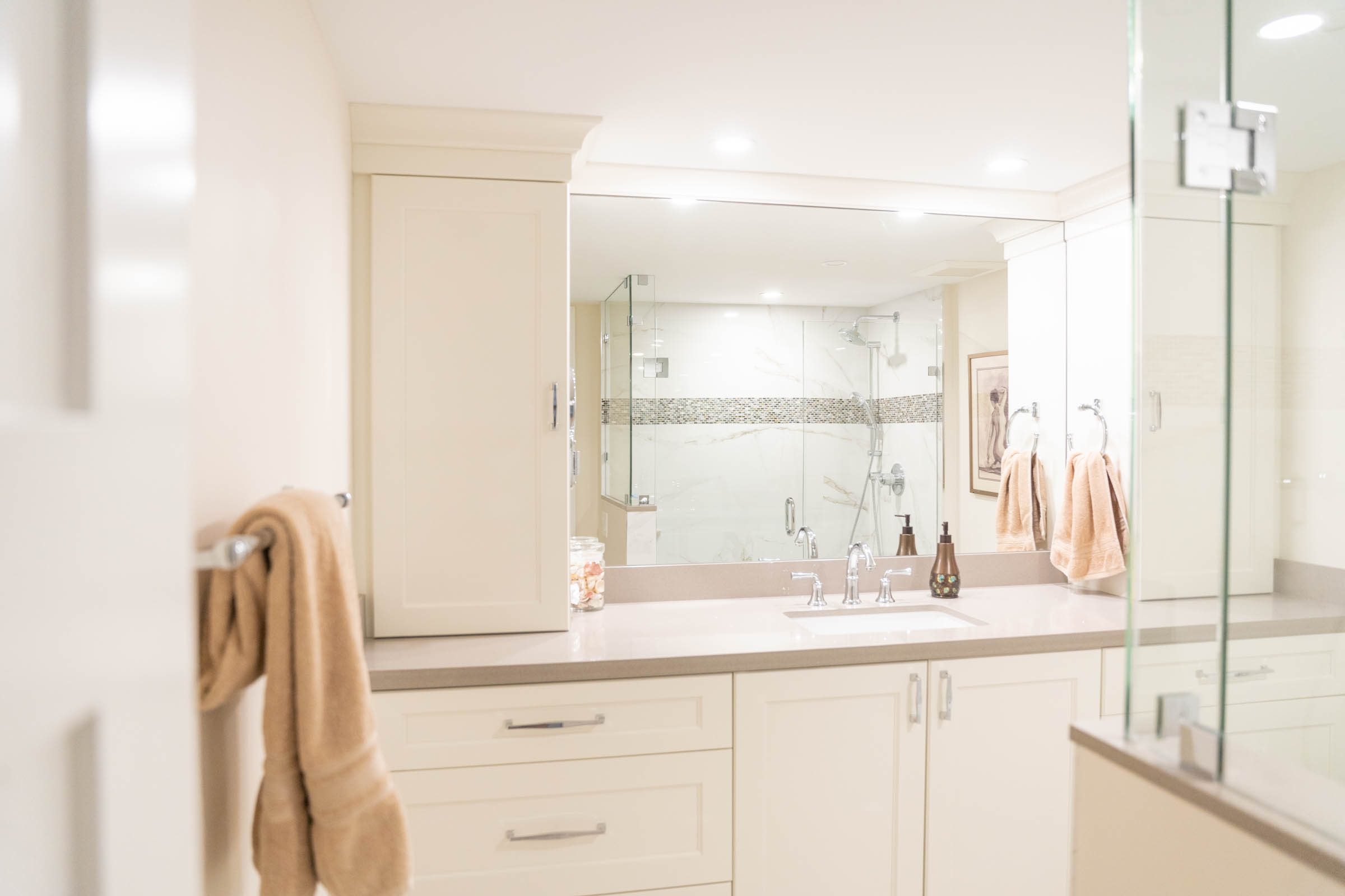 A modern bathroom featuring a glass shower door and a sleek sink, showcasing a clean and stylish design.